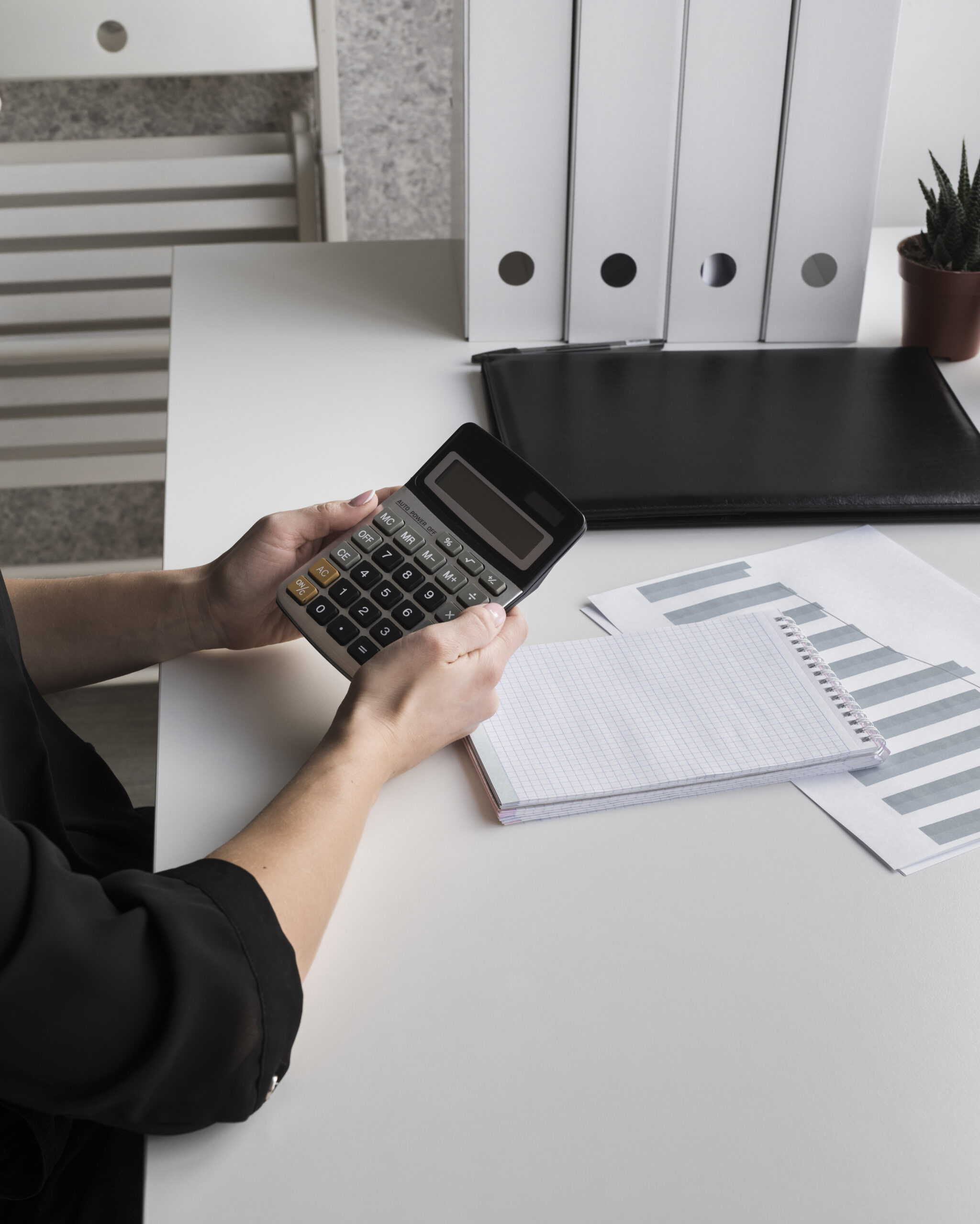 high-angle-business-woman-holding-calculator